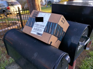 Package left by USPS carrier on top of mailboxes